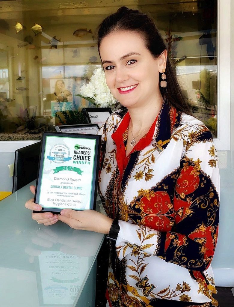 Anaida holding Readers Choice Award plaque