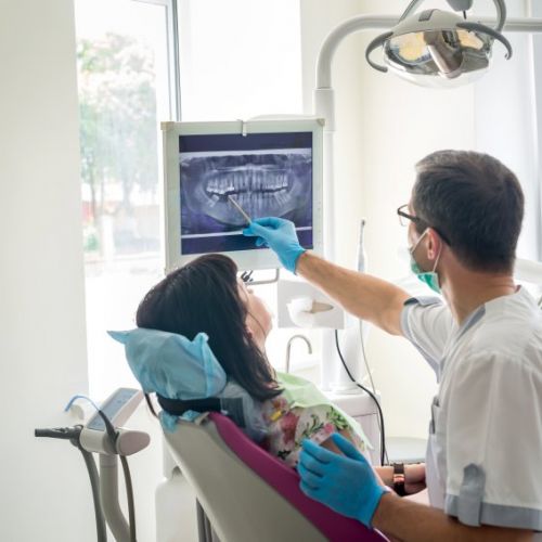 dentist showing patient root canal