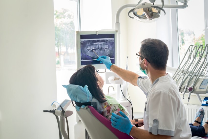 dentist showing patient root canal